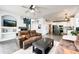 Inviting living room featuring a cozy fireplace, hardwood floors, and an open layout to the kitchen at 10890 Willow Reed West Cir, Parker, CO 80134