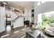 Inviting living space with hardwood floors, staircase, fireplace, and plenty of natural light, ideal for relaxation at 10890 Willow Reed West Cir, Parker, CO 80134