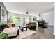 Cozy living room featuring hardwood floors, comfortable seating, a fireplace, and access to an outdoor space at 10890 Willow Reed West Cir, Parker, CO 80134