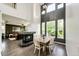 Open-concept living area with hardwood floors, a corner fireplace, and a dining area for modern living at 10890 Willow Reed West Cir, Parker, CO 80134