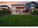 Backyard featuring a lush green lawn, and a two-story home with a patio at 7949 S Elk Way, Aurora, CO 80016