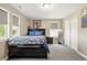 This bedroom features carpet, a neutral color scheme, a full-length mirror, and a double door closet at 7949 S Elk Way, Aurora, CO 80016