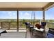 Enjoy outdoor living on the covered deck, featuring comfortable seating and serene views of the surrounding landscape at 7949 S Elk Way, Aurora, CO 80016