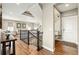 Open entryway showcasing wood floors, stairs with metal railings, and a view to living room at 7949 S Elk Way, Aurora, CO 80016