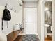 Cozy entryway with a built-in bench, coat hooks, and a view of the adjacent powder room at 7949 S Elk Way, Aurora, CO 80016