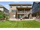 Back of home with patio and stairs leading to the 2nd story with a well maintained yard at 7949 S Elk Way, Aurora, CO 80016