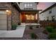 Inviting front porch with hanging flower baskets, a seating area, and attractive landscaping at 7949 S Elk Way, Aurora, CO 80016