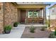 Inviting front porch with hanging flower baskets, a seating area, and attractive landscaping at 7949 S Elk Way, Aurora, CO 80016