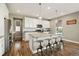 Kitchen island with stainless appliances, pendant lights, and room for counter seating at 7949 S Elk Way, Aurora, CO 80016