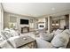Bright, open living room with fireplace, hardwood floors, and comfortable seating at 7949 S Elk Way, Aurora, CO 80016