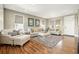 Bright living room featuring hardwood floors, neutral decor, and large windows for natural light at 7949 S Elk Way, Aurora, CO 80016