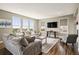 Inviting living room filled with natural light, comfortable seating, and hardwood floors at 7949 S Elk Way, Aurora, CO 80016