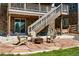 Cozy patio with stone flooring, complete with a fire pit and chairs, ideal for relaxing and entertaining at 7949 S Elk Way, Aurora, CO 80016