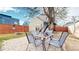 Outdoor patio with a dining table, chairs, fire pit, and a backdrop of modern homes beneath a partly cloudy sky at 3825 Tejon St, Denver, CO 80211