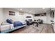 Finished basement with stylish furniture, a cozy bed, and a modern entertainment setup at 3825 Tejon St, Denver, CO 80211
