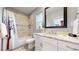 Stylish bathroom featuring a shower/tub combo, gray tile floors, and vanity with white cabinet storage at 3825 Tejon St, Denver, CO 80211