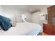 Well-lit bedroom showing wood floors, a comfy bed, an closet, and access to an ensuite bathroom at 3825 Tejon St, Denver, CO 80211