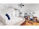 Cozy bedroom featuring hardwood floors, a ceiling fan, and a comfortable bed with a blue pillow at 3825 Tejon St, Denver, CO 80211