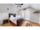 Bedroom featuring hardwood floors, a ceiling fan, and a comfortable bed with a blue pillow at 3825 Tejon St, Denver, CO 80211