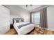 Cozy bedroom with natural light, a large window, and wood floors, creating a warm atmosphere at 3825 Tejon St, Denver, CO 80211
