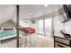 Inviting bedroom with deck access, a comfy red couch, and modern bar seating at 3825 Tejon St, Denver, CO 80211