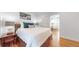 Well-lit bedroom showcasing a comfortable bed, wood floors, and convenient access to the dining room at 3825 Tejon St, Denver, CO 80211