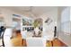 Chic dining area with a glass table, white chairs, and open access to the kitchen at 3825 Tejon St, Denver, CO 80211