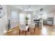 Bright dining area featuring hardwood floors, a modern chandelier, and seamless flow to the kitchen at 3825 Tejon St, Denver, CO 80211