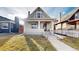 Charming two-story home with inviting front porch and well-maintained front lawn at 3825 Tejon St, Denver, CO 80211