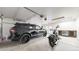 Spacious garage with room for a car and motorcycle, featuring ample lighting and storage at 3825 Tejon St, Denver, CO 80211