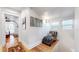 Bright hallway with a leather chaise lounge and wood floors, offering a peaceful spot at 3825 Tejon St, Denver, CO 80211