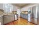 Charming kitchen featuring stainless steel appliances, light granite countertops, and tiled backsplash with wood floors at 3825 Tejon St, Denver, CO 80211