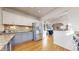 Bright kitchen features two-tone cabinets, stainless steel appliances, granite countertops, and hardwood floors at 3825 Tejon St, Denver, CO 80211