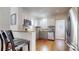 Efficient kitchen with stainless steel appliances, granite countertops, and eat in bar area at 3825 Tejon St, Denver, CO 80211