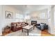 Cozy living room featuring a decorative fireplace, comfortable seating, and natural light at 3825 Tejon St, Denver, CO 80211