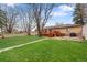 Manicured backyard with a wooden deck perfect for outdoor entertaining at 60 Yarrow St, Lakewood, CO 80226