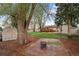 Secluded backyard with a fire pit and mature trees at 60 Yarrow St, Lakewood, CO 80226