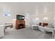 Cozy basement living room features a brick fireplace, comfortable seating, and ample lighting at 60 Yarrow St, Lakewood, CO 80226