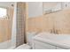 Clean bathroom features tiled walls, a modern vanity, and a shower/tub with a patterned curtain at 60 Yarrow St, Lakewood, CO 80226