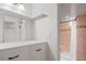 Bright bathroom with white vanity, drawers, and a shower with decorative tile at 60 Yarrow St, Lakewood, CO 80226