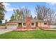 Charming ranch-style home featuring a brick chimney and attached two-car garage at 60 Yarrow St, Lakewood, CO 80226