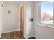 Entryway with hardwood floors and a decorative wooden front door at 60 Yarrow St, Lakewood, CO 80226