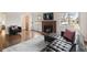 Cozy living room features a brick fireplace, hardwood floors, and comfortable seating at 60 Yarrow St, Lakewood, CO 80226