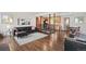 Open-concept living room with hardwood floors and black leather seating at 60 Yarrow St, Lakewood, CO 80226
