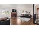 Bright living room features a brick fireplace and comfortable leather furniture at 60 Yarrow St, Lakewood, CO 80226