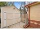 An outdoor storage shed with neutral paint and a chain-link fence nearby at 60 Yarrow St, Lakewood, CO 80226