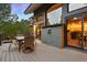 Relaxing outdoor deck with a table, chairs, and views of the surrounding landscape at 3816 Spring Valley Trl, Evergreen, CO 80439