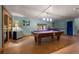 Basement entertainment room with a pool table, ample lighting, and stylish decor, perfect for gatherings at 3816 Spring Valley Trl, Evergreen, CO 80439