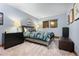Comfortable bedroom featuring a colorful bedspread, black dresser, and a window providing natural light at 3816 Spring Valley Trl, Evergreen, CO 80439