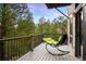 Relaxing deck area with a hanging chair and a view of the surrounding forest at 3816 Spring Valley Trl, Evergreen, CO 80439